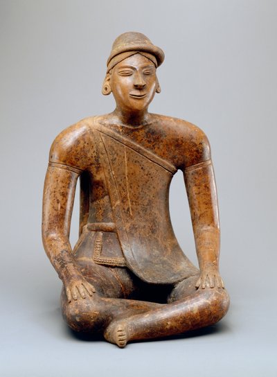 Seated male with cape by Colima Culture
